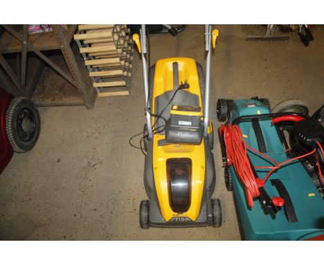 A Stiga SLM 536AE electric rechargeable lawn mower with battery and charger
