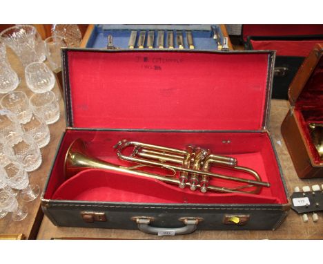 A cased brass trumpet