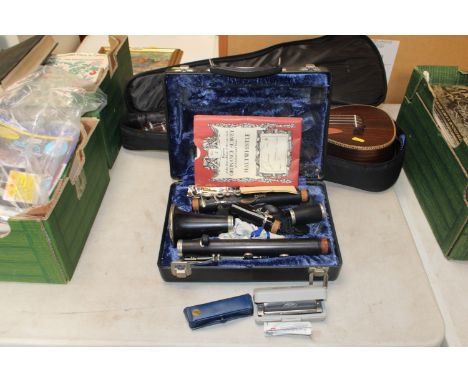 A cased clarinet and two mouth organs