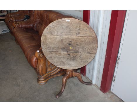 An oak snap top table raised on tripod base AF