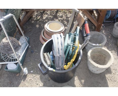 A quantity of garden planters and a plastic bin with a quantity of garden tools, garden kneeler, army folding shovel etc 