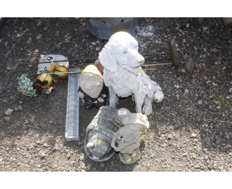 A quantity of garden ornaments, stakes and a small feeder