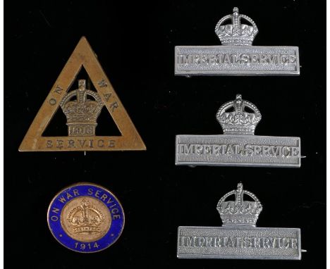 Three World War I white metal Imperial Service badges, pin fittings to the reverse, together with a gilding metal and enamel 