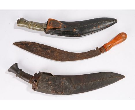 Gurkha Kukri, carved wooden handle, skinning knives still present in scabbard, overall length 41 cm, together with a souvenir