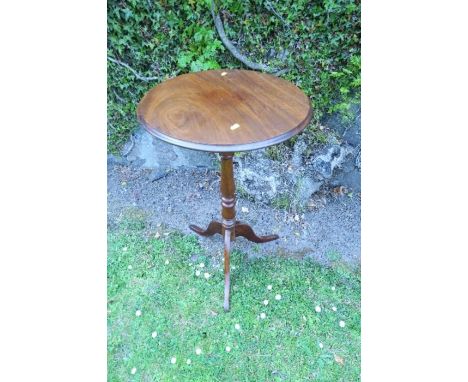 A circular mahogany occasional table, raised on a turned column, terminating in a tripod base, diameter 18ins x height 30.5in