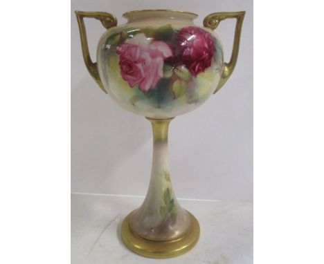 A Royal Worcester vase, raised on a pedestal, decorated with roses to gilt lug handles, shape number 2736, height 7.5ins