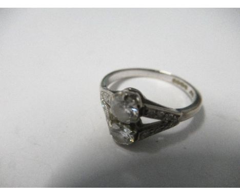 A white gold two stone ring, with white stone chips to the shoulders, finger size M