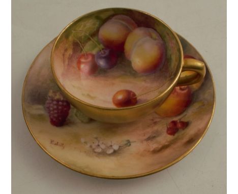 A Royal Worcester miniature cabinet cup and saucer, the interior of the cup and the saucer decorated with fruit to a mossy ba