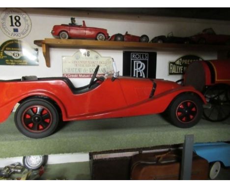 A Morgan pedal car, having swing pedals, and solid rubber tyres, approx. 48” x 18”