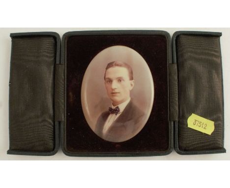 An oval photographic print on metal, portrait of a man, in leather covered travelling case, the easel support marked Van Ralb
