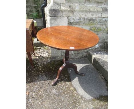 A 19th century oak circular occasional table, raised on a turned column support terminating in a tripod base, diameter 28.75i