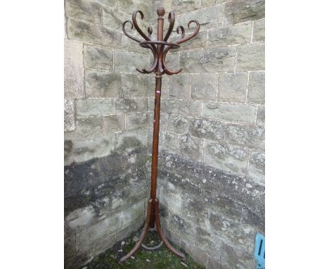 A bentwood coat stand, with six scrolling hooks and raised on a tripod base, height 78ins