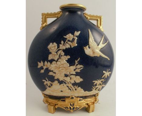 A Royal Worcester moon flask, the blue ground embossed in white and gilt flowers and bird, with gilt handles and base, height