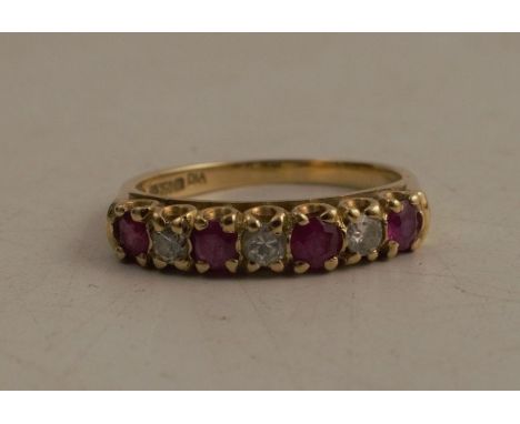 A gold ring, set with alternate rubies and diamonds, marked 750, total weight 3.4g