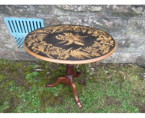 An oval occasional table, having a fern work decorated top, raised on a tripod base, max diameter 24ins x 18ins x height 23in