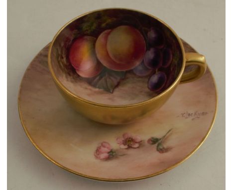 A Royal Worcester miniature cabinet cup and saucer, the interior of the cup and the saucer decorated with fruit to a mossy ba