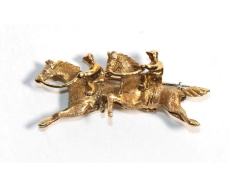 An 18 carat gold brooch modelled as two horses, stamped 'ITALY', length 4cm.  Gross weight 6.36 grams. 