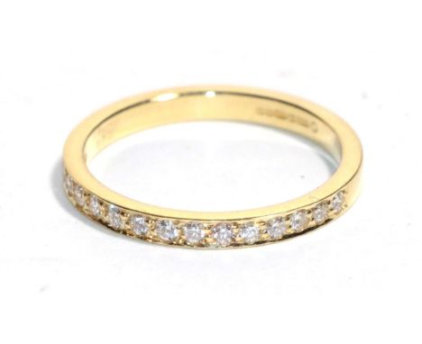 An 18 carat gold diamond half hoop ring, total estimated diamond weight 0.30 carat approximately, finger size N.  Gross weigh