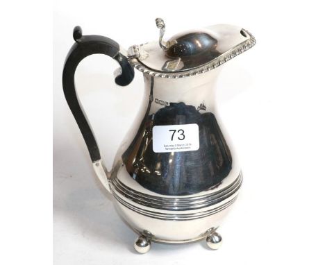 A silver baluster hot water jug, William Hutton, Sheffield 1919, with gadroon rim on ball supports, 18.5cm high, 15.4ozt 
