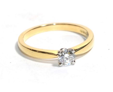 An 18 carat gold solitaire diamond ring, a round brilliant cut diamond in a claw setting, to knife edge shoulders, estimated 