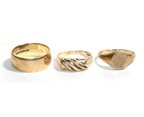 A 9 carat gold band ring, finger size R1/2; a 9 carat gold signet ring, finger size Q1/2; and another 9 carat gold ring (cut)