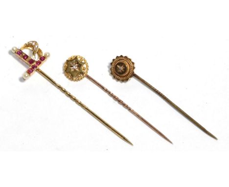 Three stick pins, two stamped '15CT', the other '18' (3) .  Two 15 carat pins - 2.39 grams. The other stamped '18' - 1.85 gra