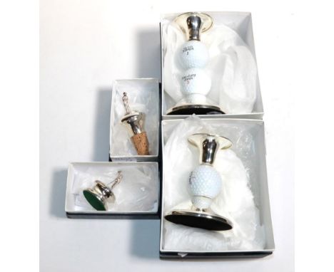 Two silver and golf ball candlesticks; a silver paperweight with golfer finial; and a silver bottle stopper with a cricketer 