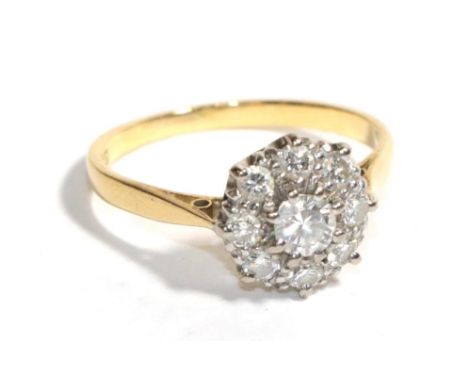A diamond cluster ring, stamped '18CT &amp; PLAT', finger size M.  Gross weight - 2.78 grams.