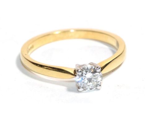 An 18 carat gold solitaire diamond ring, a round brilliant cut diamond in a claw setting, to knife edge shoulders, estimated 