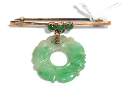 A bar brooch stamped '9ct' with a jade bi-disc suspended, drop measures 3.5cm.  Gross weight - 5.02 grams 