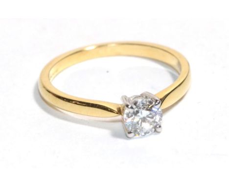 An 18 carat gold solitaire diamond ring, a round brilliant cut diamond in a claw setting, to knife edge shoulders, estimated 