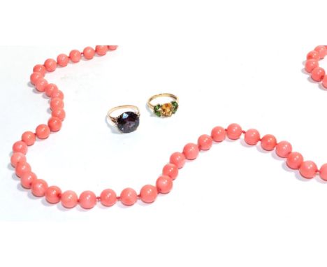 A coral necklace with clasp stamped 14k, length 96cm; a 9 carat gold citrine and tourmaline ring, finger size O; and a synthe