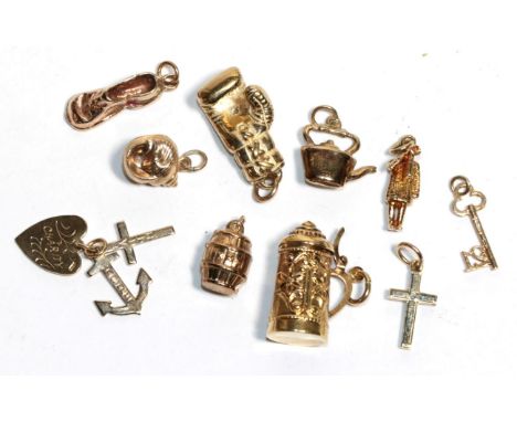 Ten charms including a cross, a shell, a boxing glove etc (10).  8 hallmarked for 9 carat gold, the remaining two unmarked. 9
