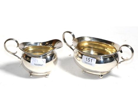 A silver sugar bowl and cream jug, William Hutton, Sheffield 1921, oval on ball feet, 15.1ozt  