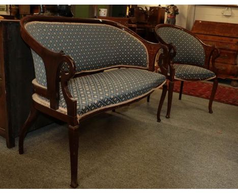 An Edwardian inlaid mahogany two piece salon suite, upholstered in blue fabric, comprising a sofa and a chair (a.f.).  Sofa w