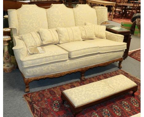 A Georgian style three-piece suite comprising a three seater sofa and pair of wing back armchairs (with differing upholstery)