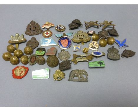 A collection of badges, button including a silver A.R.P badge and other items of military interest  