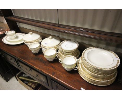 Wedgwood Cream and Gilt Dinnerware, pattern number W4001 comprising 2 Lidded Tureens, 2 Meat Plates, 8 Soup Bowls and Saucers