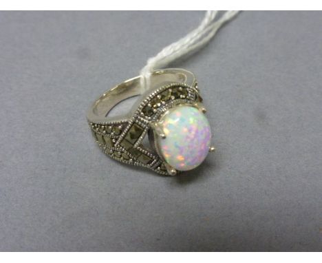 A silver art deco style ring inset with marcasite's and large central opal