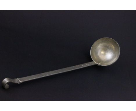 Large metal ladle with military markings to the handle