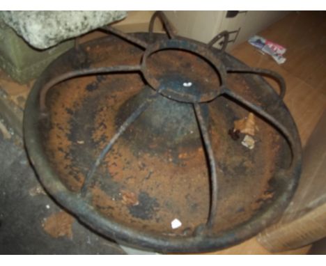 AN ANTIQUE CAST IRON ROUND CHICKEN FEEDER THROUGH PLANTER