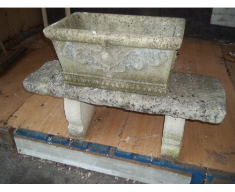 A CONCRETE GARDEN BENCH AND PLANTER