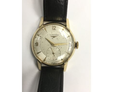 A gents vintage 14K gold Longines automatic wristwatch with Arabic and baton numerals as well as a subsidiary seconds dial, m
