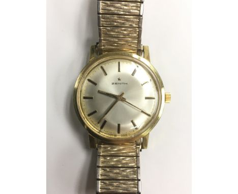 A gents vintage Zenith automatic wristwatch with baton numerals, serial number 121D566, mounted on a gold tone flexi strap.