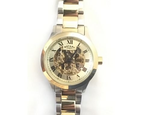 A boxed Gents Rotary skeleton wristwatch with blue hands, Roman numerals and two time strap.