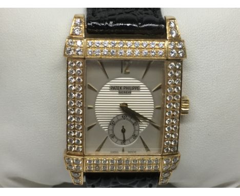 A Patek Philippe Gentlemans dress watch, The solid 18ct gold cased set with high grade brilliant cut diamonds in two rows and