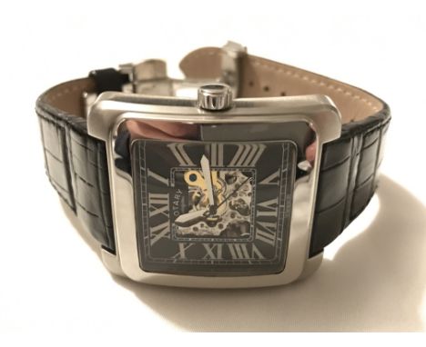 A boxed gents Rotary 1895 edition automatic skeleton wristwatch. The dark square dial presenting Roman numerals mounted in a 