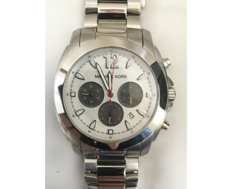 A boxed Gents Michael Kors chronograph wristwatch with light metallic dial, baton numerals and a large Arabic 12, three dark 