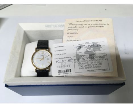 An 18carat Gold Gents Tissot Watch with black leather strap. Orgional box paperwork and certificate. Not seen working quartz 