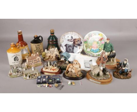 An assortment of ceramics and enamel collectors badges. To include two Wade Bell's Whiskey ceramic bells, four Lilliput lane 